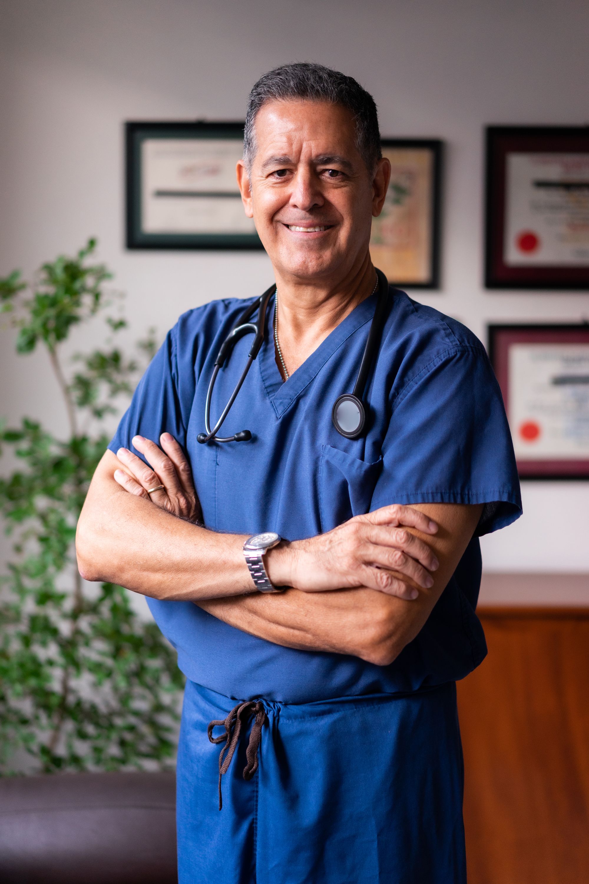 Male clinician in scrubs, representative of the international medical workforce in the UAE.