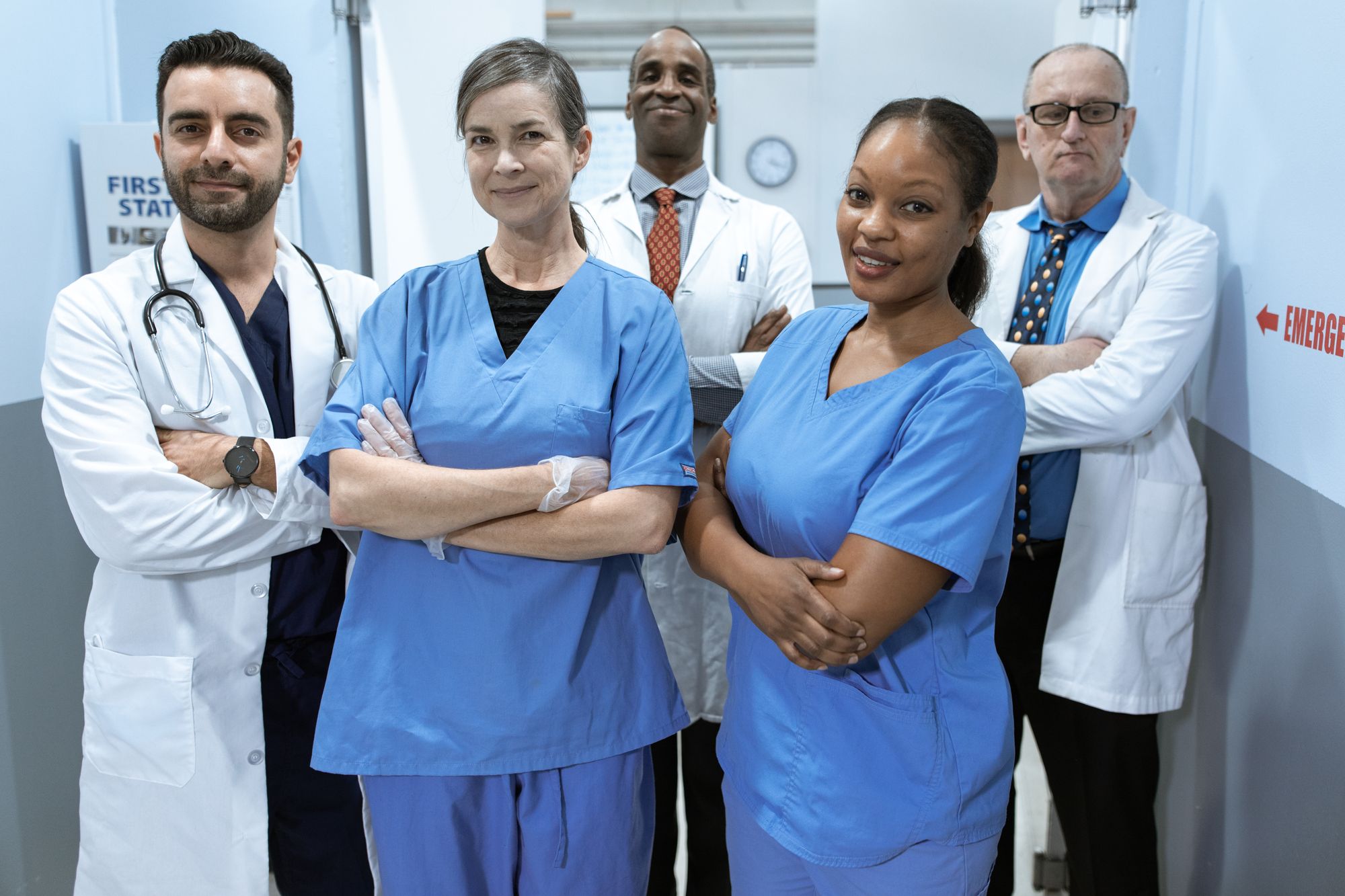 Diverse group of clinicians in a hospital corridor, representative of Dubai’s international medical workforce.